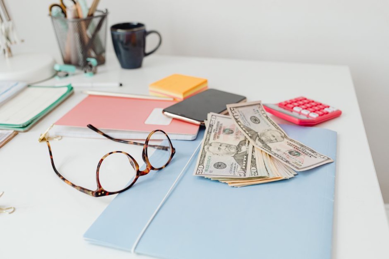 Stack of bills and a calculator - African Bank loans under debt review