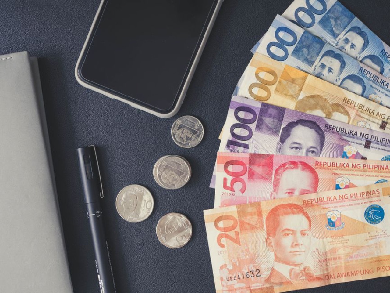 Bills and coins on a table - Debt review fees and costs explained