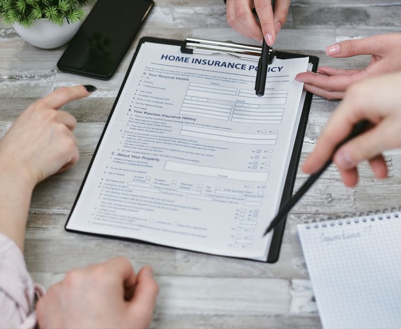 Advisor pointing at form - Debt review vs debt consolidation