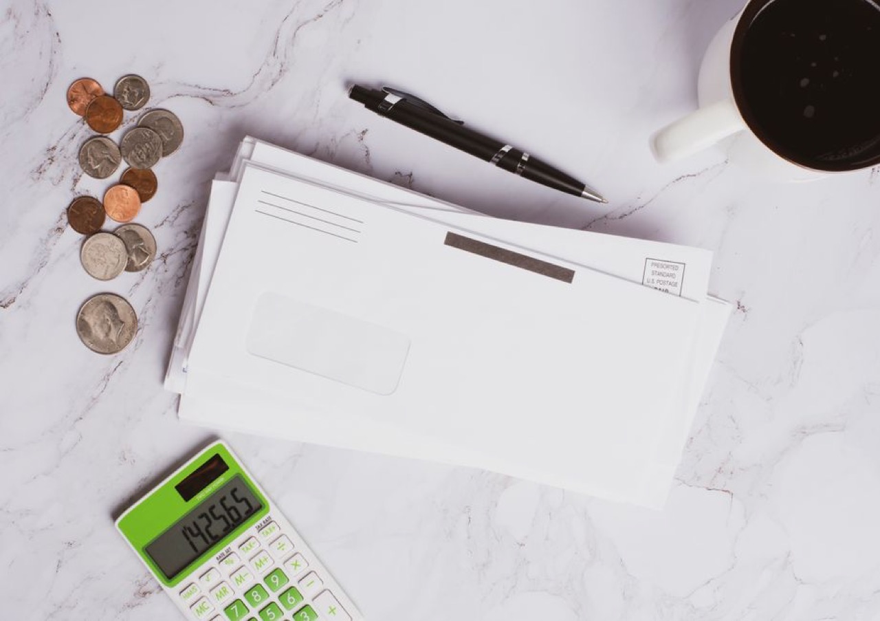 Stack of bills and a calculator - NCR debt review removal explained