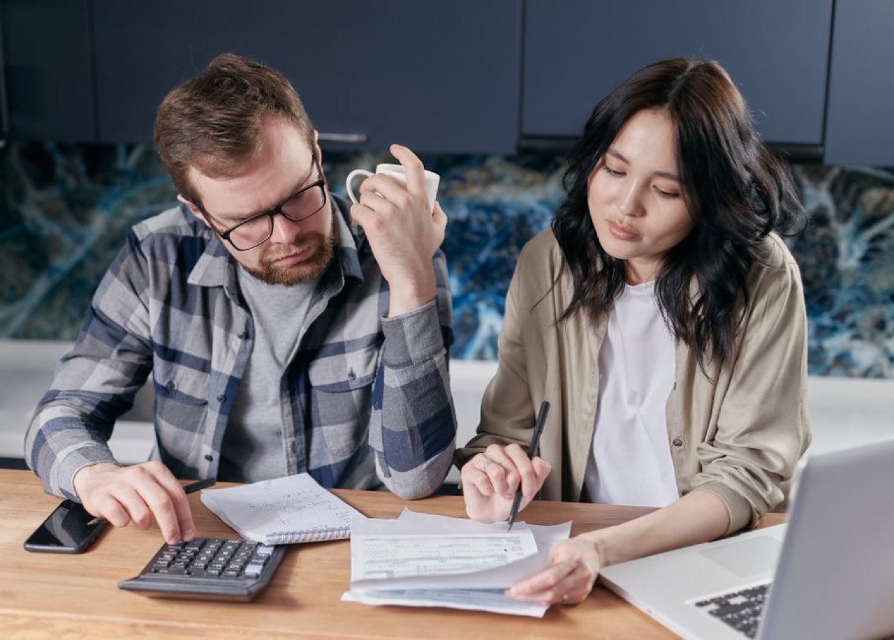 Looking at finances on laptop - What is debt review?