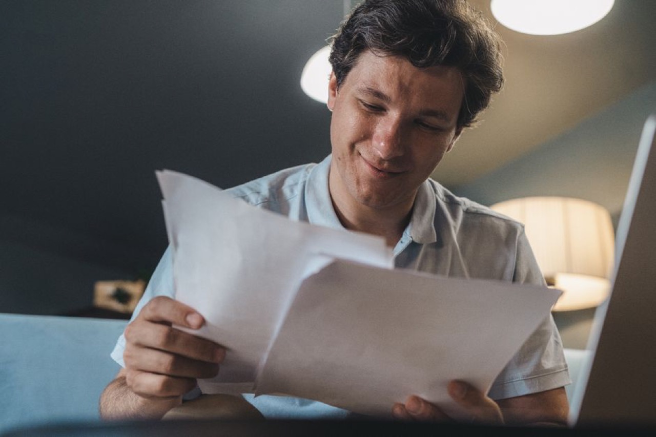 Happy person reviewing documents - Debt management companies in South Africa