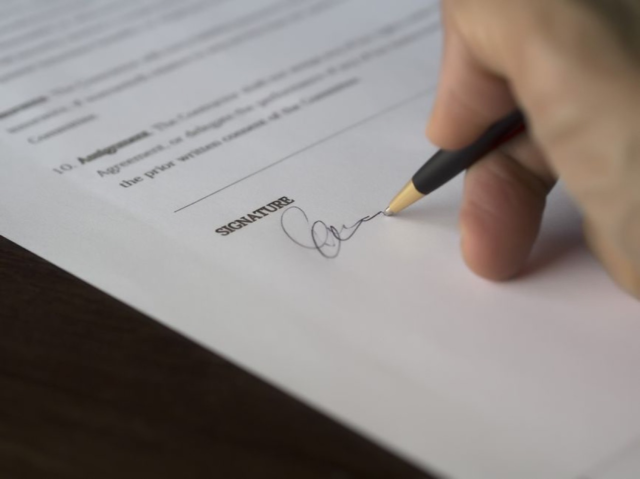Signing paperwork close up - Acknowledgement of debt (AOD) template