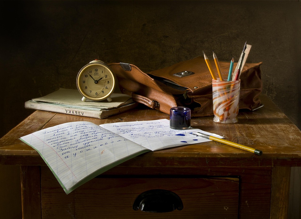 Writing a letter at desk - Debt review fees explained
