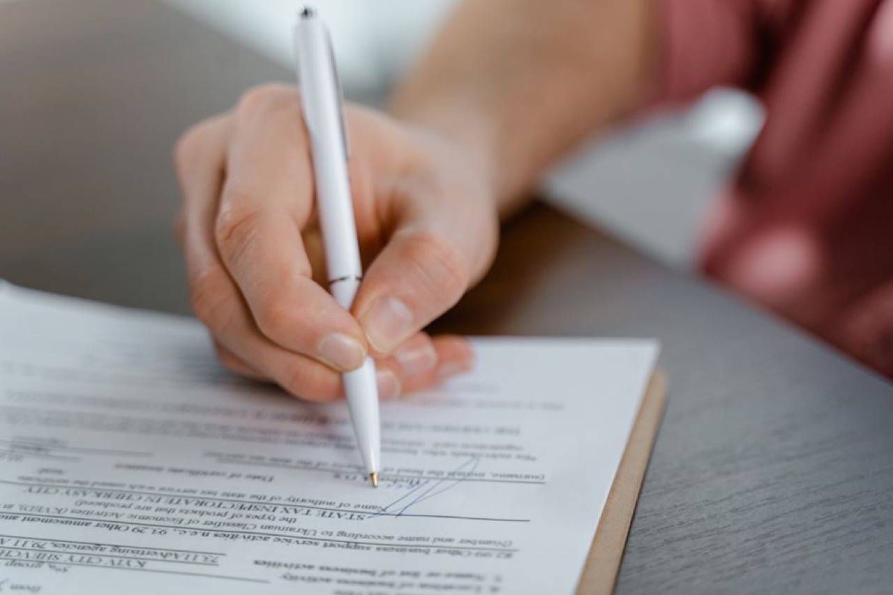 Signing paperwork close up - Letter to challenge a garnishee / emoluments order (template)