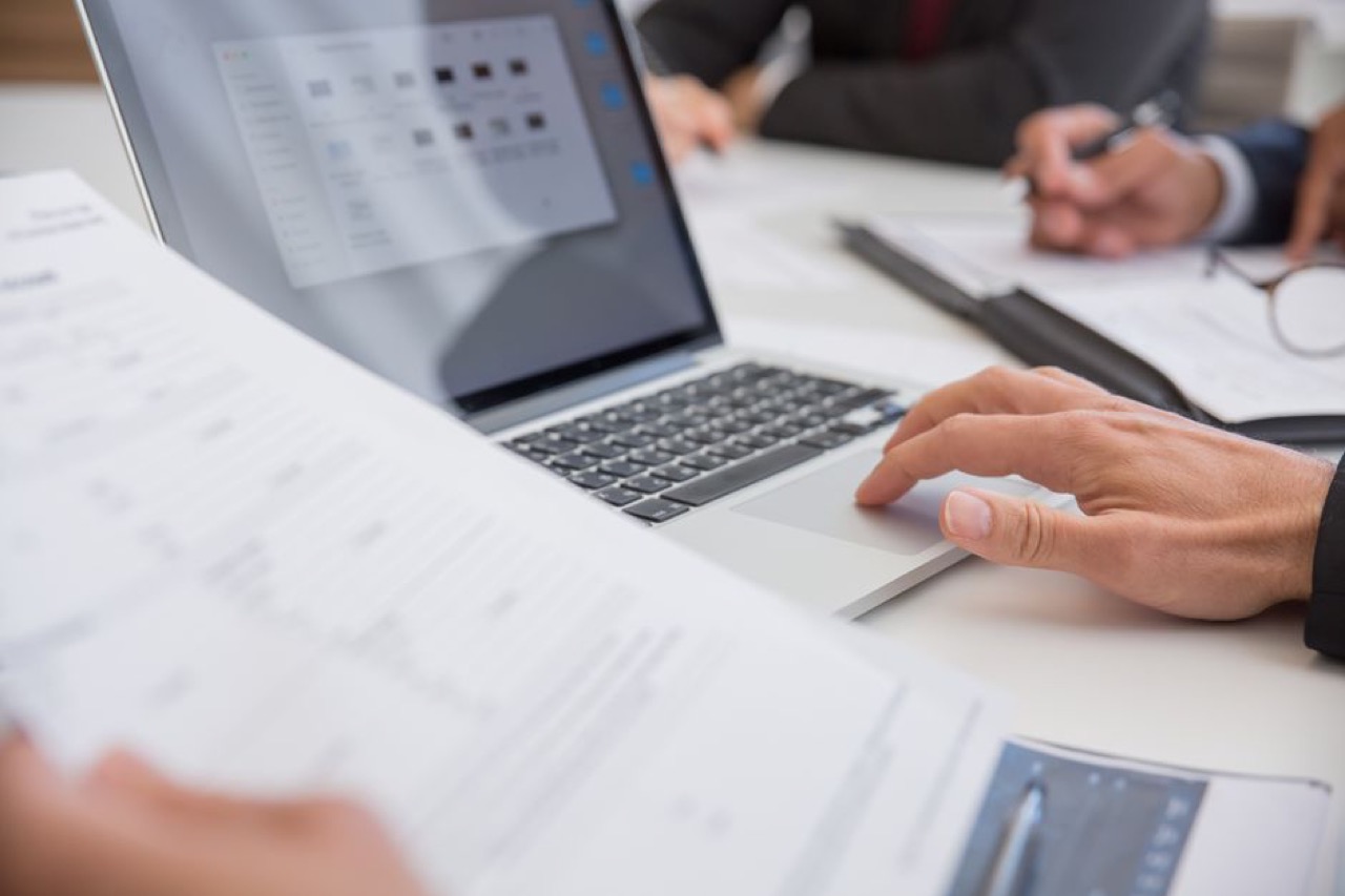 Laptop and documents on desk - Letter to creditors when you cannot pay (template)